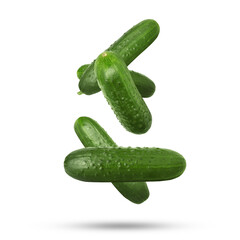 Whole ripe cucumbers falling on white background