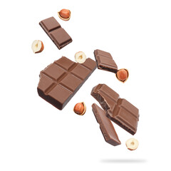 Pieces of tasty chocolate and hazelnuts falling on white background