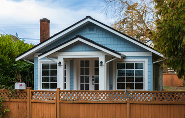 Country house in North America. Wooden house in green forest. wooden country house or cottage with wooden fence.