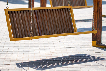 wooden bench in city park in summer