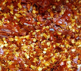 Closeup of crushed chili red pepper flakes and seed. Ingredients of types of Thai food. 