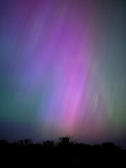 Gorgeous and rare extreme solar storm creating rare Northern Lights or Aurora Borealis in an amazing light show over Onchan on the Isle of Man