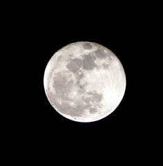 The mesmerising full moon shines brightly in a clear night sky