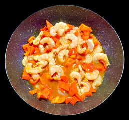 Delicious plate of seasoned sautéed prawns and red peppers in a luxurious culinary combination for a fine dinner