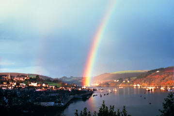 A brilliant rainbow arcs over Dartmouth Devon England after a storm