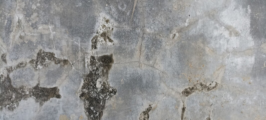 A rough, weathered concrete wall with cracks, discoloration, and a distressed, aged texture