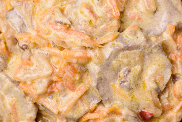 Delicious boiled beef or pork tongue sliced with carrots, onions, sour cream