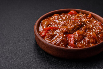 Thai Asian dish with meat, hot pepper, tomato sauce and sesame
