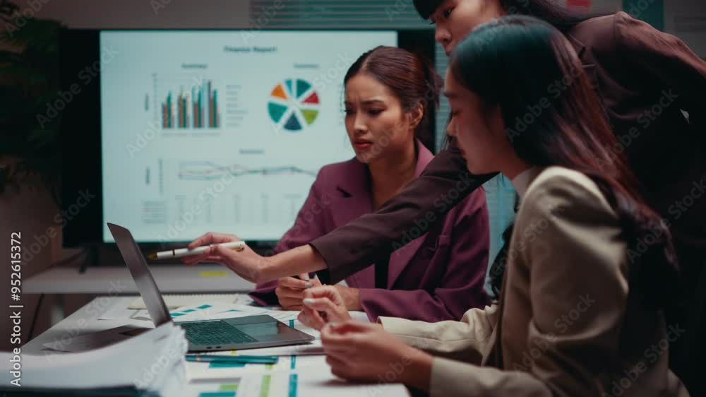 Aufkleber Diverse business team is intensely collaborating, analyzing financial data displayed on a laptop, with charts projected on a screen in the background