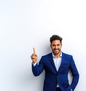 A confident businessman in a blue suit points up, ready to share an idea or achievement against a clean white background.