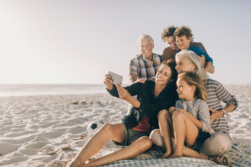 Multi-generational family taking a selfie together on the beach