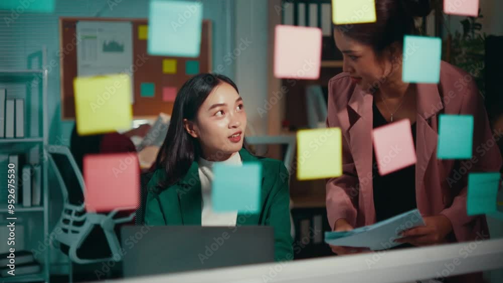 Poster two businesswomen are brainstorming and discussing a new project. they are using sticky notes on a g