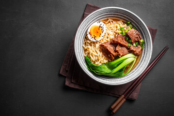 Ramen Asian noodles soup with beef, egg and pak choi