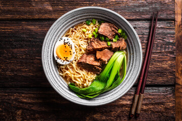 Ramen Asian noodles soup with beef, egg and pak choi