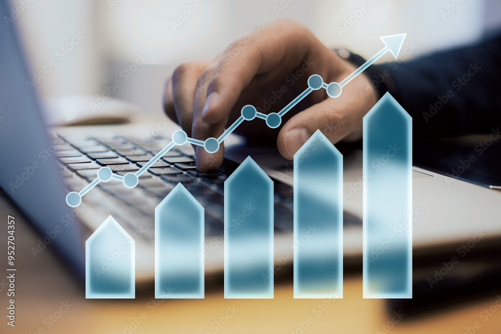 Poster hand typing on laptop with upward arrow and bar chart overlay symbolizing growth and financial succe