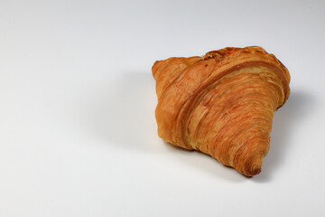 Freshly baked croissant,  Brown crispy croissants isolated on white background. French pastry closeup photo. Buttered bread croissant isolated on white background.