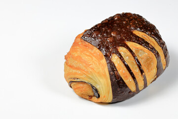 Freshly baked croissant, Chocolate Praline croissant isolated on white background. French pastry closeup photo. Buttered bread croissant.