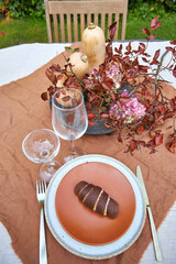 fall garden table setting with pumpkins and hydrangea in brown and burgundy tones