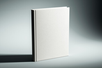 Blank beige hardcover book standing on a light grey background. 3D Rendering