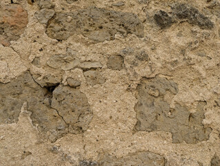 Close-Up of a Vintage Ocher Stone Wall with Subtle, Abstract Texture, Perfect for Rustic Backgrounds, Architectural Design, and Textured Projects