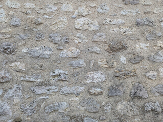 Abstract Close-Up of a Uniform Stone Wall with Subtle Grunge Texture, Ideal for Rustic Backgrounds, Architectural Projects, and Creative Designs Requiring Depth and Authenticity