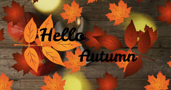 Image of hellow autumn text over cutlery and autumn leaves over wooden background - Powered by Adobe