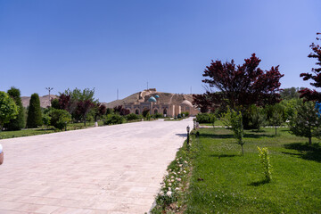 A path leads to a building with a blue dome