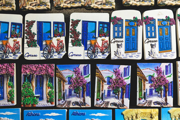 Traditional tourist souvenirs and gifts from Athens, fridge magnets with text "Athens", and key ring keychain, mugs and toys in a local vendor shop in Plaka district, Attica, Greece, greek souvenirs