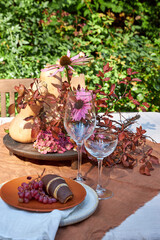 fall garden table setting with pumpkins and hydrangea in brown and burgundy tones