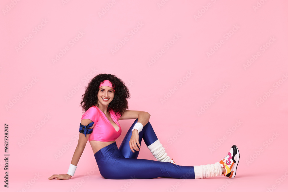 Wall mural Aerobics. Happy woman in sportswear on pink background