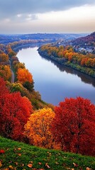 An aerial view of a river winding through a forest with vibrant fall foliage.