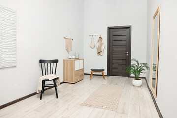 Stylish hallway with big mirror and chest of drawers. Interior design