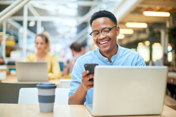 Phone, black man and laptop in office for research, planning and reading for article information. Workplace, happy journalist and digital with cellphone for mobile app, results and publication ideas