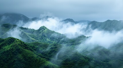 Green mountains with low-hanging clouds in a tranquil scene