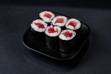 Classic Tuna Maki Rolls on a Black Plate