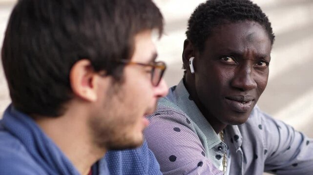 interracial friendship - young african man tells his experiences to his friend