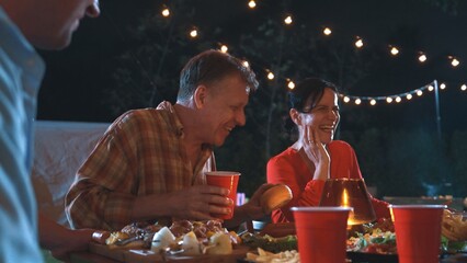 Family gather for holiday celebration. Focus old mother, father and middle age son together eat dinner party. Outdoor activity for spending time with lovely relatives cross generation gap. Divergence.