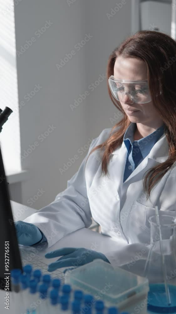 Poster female scientist conducting research in a modern laboratory setting using laptop and test tubes