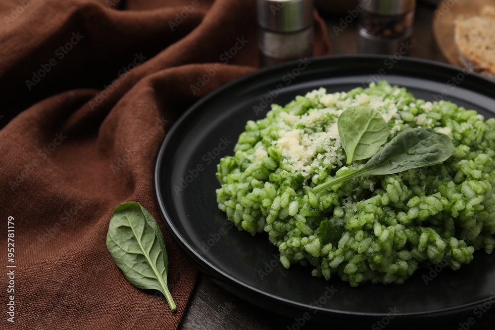 Wall mural delicious spinach risotto with parmesan cheese served on table, closeup