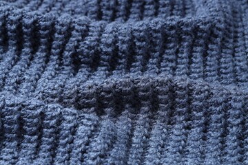 Texture of blue knitted fabric as background, closeup