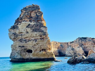 Oddly shaped jagged rock formations and cliffs at Lagoa Beach, Faro District, Southern Portugal.
