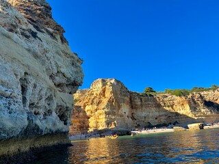 Oddly shaped jagged rock formations and cliffs at Lagoa Beach, Faro District, Southern Portugal.