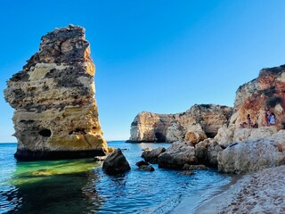Oddly shaped jagged rock formations and cliffs at Lagoa Beach, Faro District, Southern Portugal.