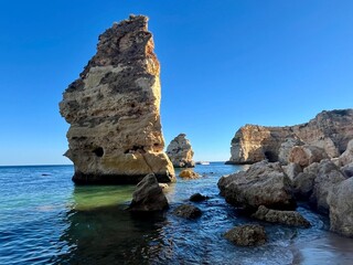 Oddly shaped jagged rock formations and cliffs at Lagoa Beach, Faro District, Southern Portugal.