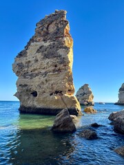 Oddly shaped jagged rock formations and cliffs at Lagoa Beach, Faro District, Southern Portugal.