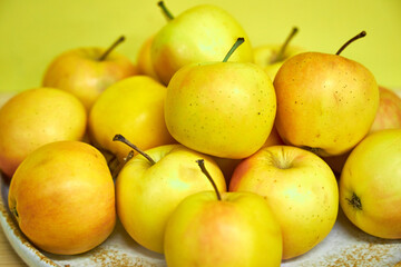 Modern minimalist still life with yellow apples on yellow background