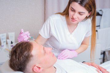 Male cosmetics. Good looking man receiving face treatment at luxury spa