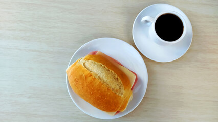  Cup of coffee and french bread on the plate and with copy space.
