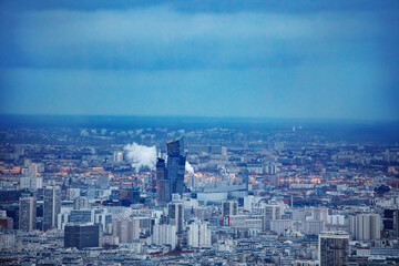 Fototapeta premium Last sun beams falling on Paris roofs before dusk, aerial view