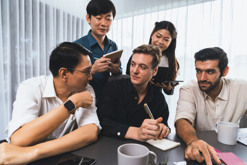 Group of diverse office worker employee working together on strategic business marketing planning in corporate office room. Positive teamwork in business workplace concept. Prudent